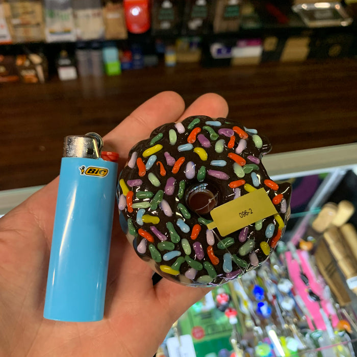 Empire Glassworks Sprinkle Donut Hand Pipe With Bic Lighter In hand top view