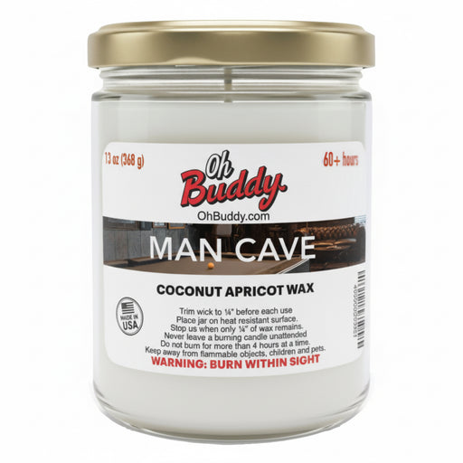 Candle jar labeled 'Oh Buddy Man Cave' with coconut apricot wax on a white background